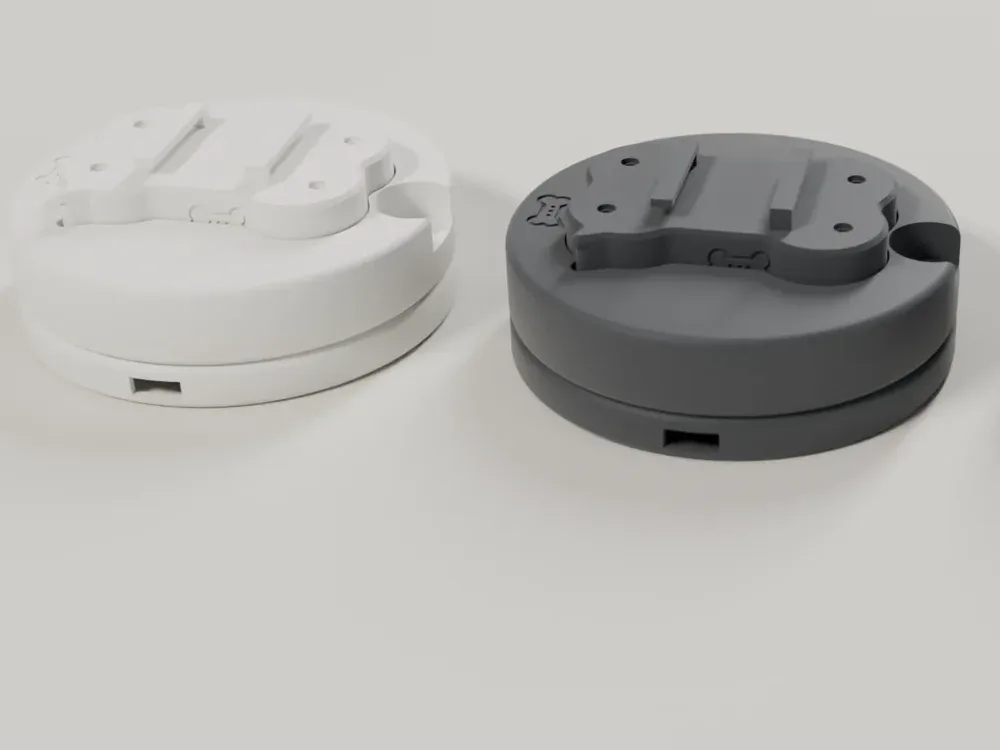 Render of two Lite bases side by side, one white and one graphite, each with the tag seated in its top.